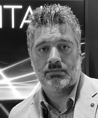 Black and white portrait of a man with a beard and graying hair.