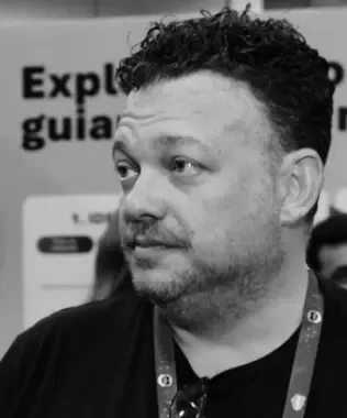 Black and white portrait of a man with a beard, looking right.