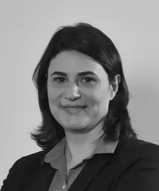 Black and white headshot of a woman with dark hair, lightly smiling.
