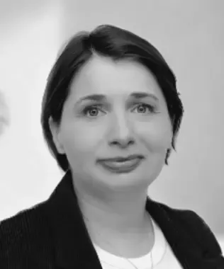 Black and white portrait of a woman with dark hair and a gentle smile.