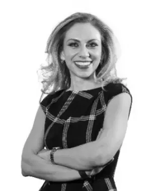 Black and white portrait of a smiling man with dark hair.