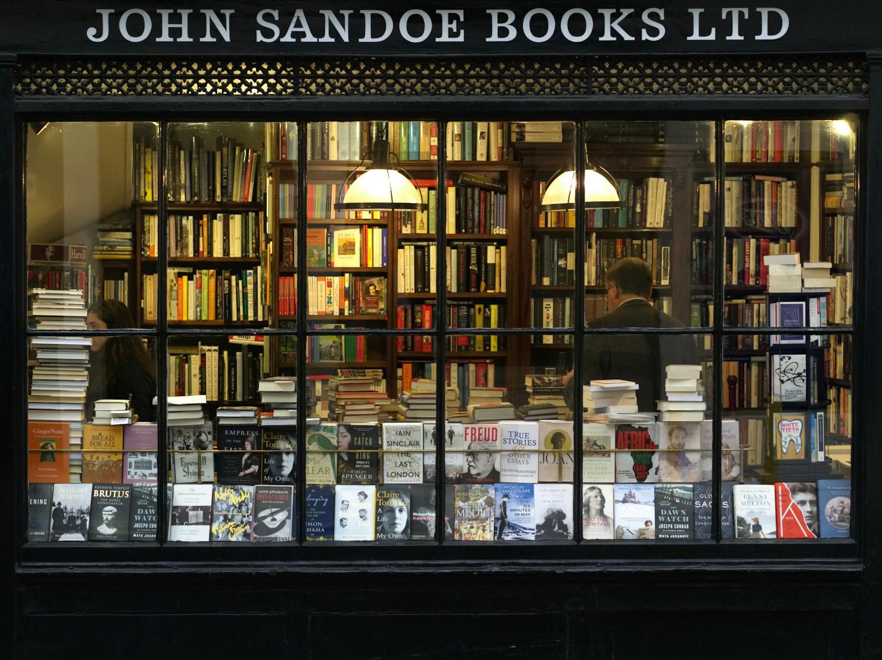Storefront of John Sandoe Books Ltd., with numerous books filling the window displays.