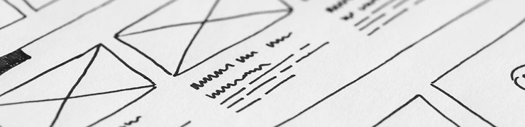 Hand-drawn wireframe or UI/UX sketch on white paper, showing various layout elements.
