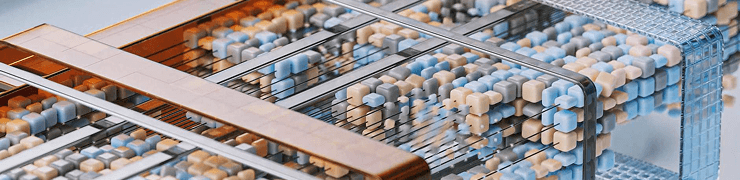 Abstract data visualization with numerous small, multicolored cubes arranged in a metallic grid structure.