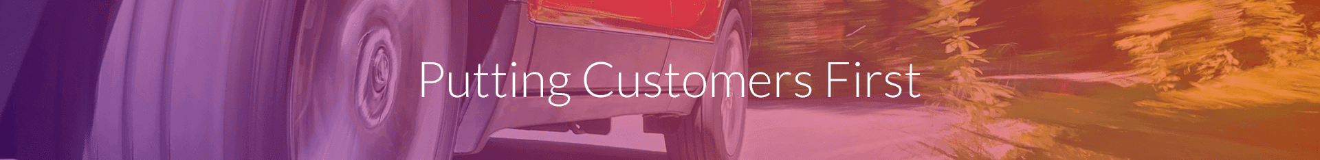 Text 'Putting Customers First' overlaying a blurred background of a truck on a road.
