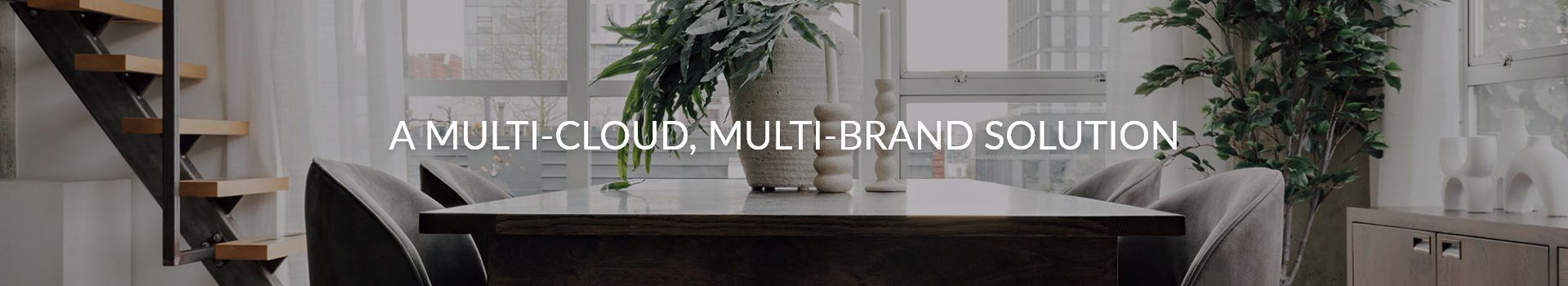 Text 'A MULTI CLOUD, MULTI BRAND SOLUTION' over a stylish indoor dining setting.