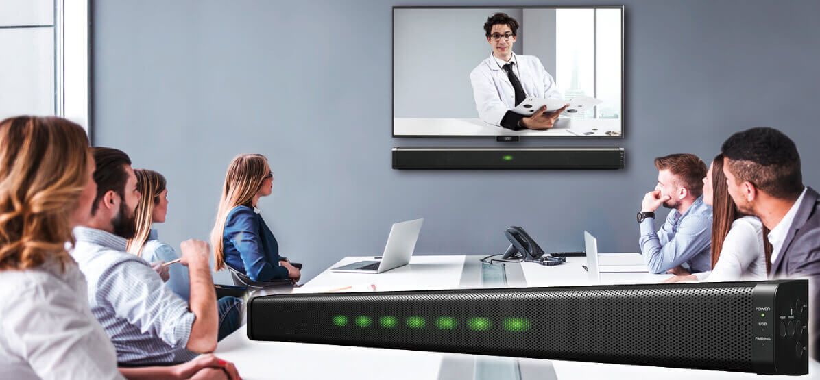 Professionals attend a video conference in a modern meeting room with a soundbar system.