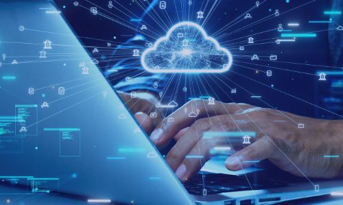 Hands typing on a laptop, connected to a glowing cloud icon, symbolizing digital cloud computing.