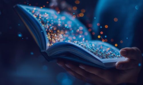 Hands hold an open book emitting sparkling, magical lights against a dark background.